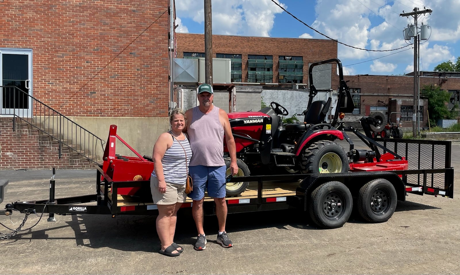 A couple standing infront of the Yanmar equipment
